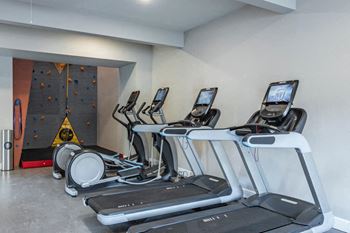 24-Hour fitness center with rock climbing wall