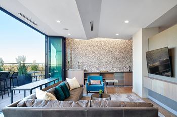 Rooftop club room with wall-to-wall glass doors