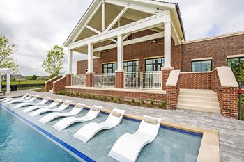 Resort-style pool with tanning ledge, in-water seating, and large sundeck