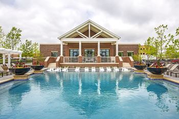 Resort-style pool with tanning ledge, in-water seating, and large sundeck