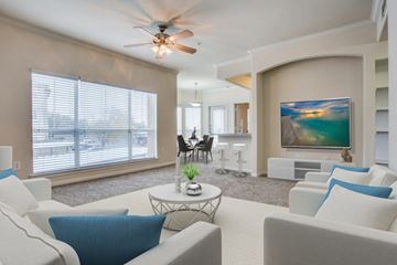 Austin apartment for rent - A living room with a white couch and a ceiling fan.