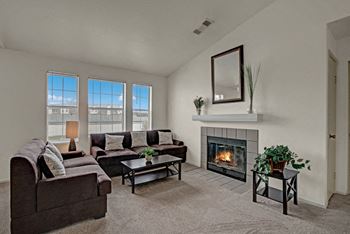 St. James place fireplace with couches, fireplace, and window