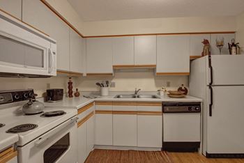 Town centre kitchen view with oven, microwave, and fridge