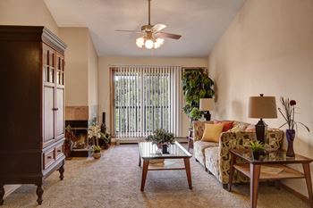 Town centre living room view with couch, balcony, and fireplace
