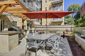 Vue outdoor patio with covered seating and grill