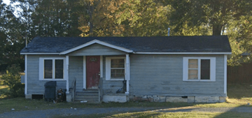 Ruston apartment for rent - a small white house with a red door