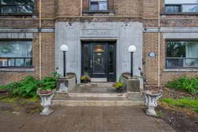 York apartment for rent - The front of a brick building with a black door and windows.