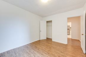 York apartment for rent - A room with a white wall and a wooden floor.