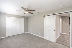 Dallas apartment for rent - Bedroom with ceiling fan and neutral tones at Chapel Creek Apartments Dallas
