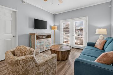 Corpus Christi apartment for rent - A living room with a blue couch and a television.