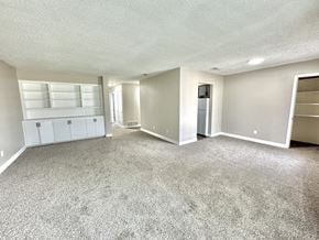 Corpus Christi apartment for rent - Large living room with grey carpet and bright natural light at Greenbriar Place 55+ Senior Apartments in Corpus Christi.