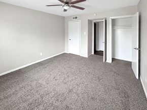 Corpus Christi apartment for rent - A room with a ceiling fan and carpeted floor.