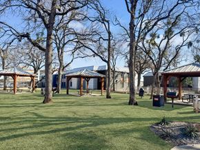 Hurst apartment for rent - Landscaped courtyard and green lawn at Verano Oaks Apartments