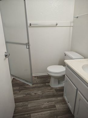 Yucaipa apartment for rent - A white toilet sits in a bathroom next to a sink.