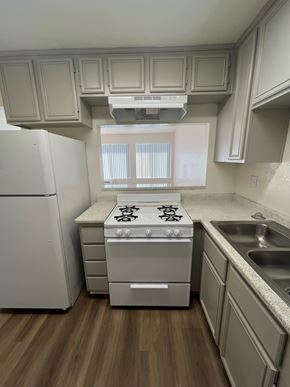 Ontario apartment for rent - A kitchen with a white refrigerator, a white stove, and a white oven.