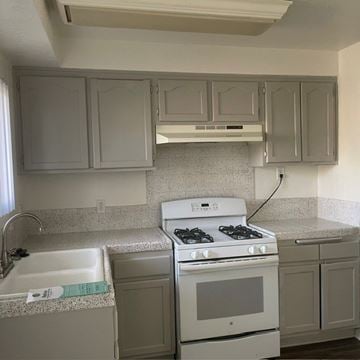 Redlands apartment for rent - A kitchen with a white stove and cabinets.
