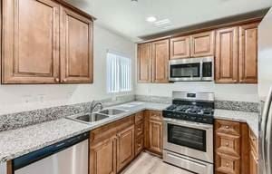 San Bernardino apartment for rent - A kitchen with wooden cabinets and a granite countertop.