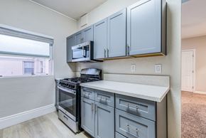 Los Angeles apartment for rent - a kitchen with gray cabinets and stainless steel appliances