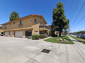 Fontana apartment for rent - A building with a parking lot in front of it.