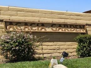 Fontana apartment for rent - A sign that says "Acacia Garden" is mounted on a tan wall.