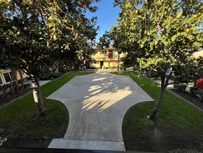 Ontario apartment for rent - A pathway between two trees with a building in the background.