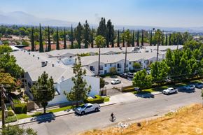 San Bernardino apartment for rent - an aerial view of a neighborhood with houses and cars and trees