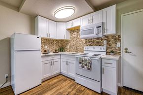 San Bernardino apartment for rent - a kitchen with white appliances and a microwave