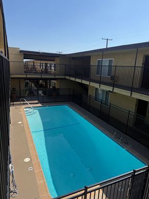 Ontario apartment for rent - A small pool in a courtyard surrounded by a black fence.