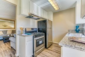 Upland apartment for rent - A kitchen with a stainless steel refrigerator and oven.