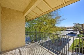Barstow apartment for rent - A balcony with a metal railing and a view of a street.