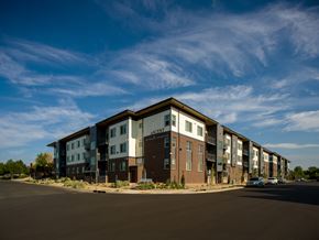 Longmont apartment for rent - Apartment complex with a car parked in front.