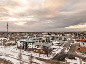 Longmont apartment for rent - A small town with a large building in the background and a road in the foreground.
