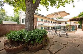 Longmont apartment for rent - A patio with a table and chairs under an umbrella.