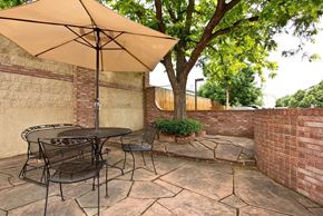 Longmont apartment for rent - A patio with a table and chairs under an umbrella.