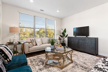 Bala Cynwyd apartment for rent - A living room with a glass coffee table and a large couch.