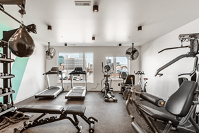 Columbus apartment for rent - A gym with a view of the city outside the window.