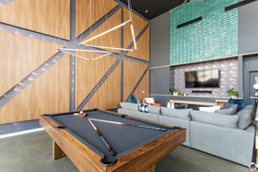 Columbus apartment for rent - A pool table is in the middle of a room with a couch and a television.