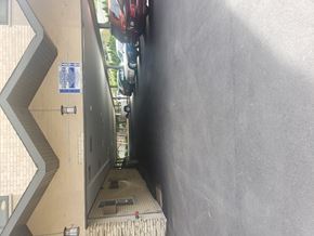 Forest Park apartment for rent - A narrow alley with a wall on one side and a metal gate on the other.
