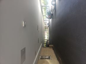 Forest Park apartment for rent - A long hallway with a black wall on the right and a white wall on the left.