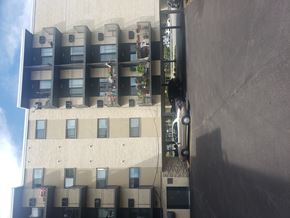 Forest Park apartment for rent - A building with a grey wall on the right side.