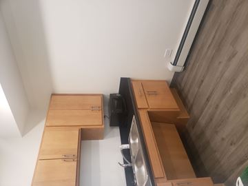 Forest Park apartment for rent - A kitchen with wooden cabinets and a black dishwasher.