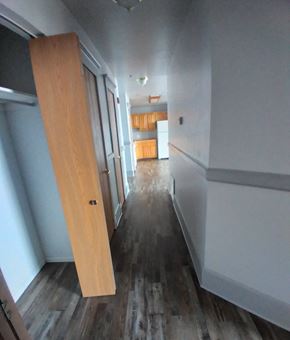 Fort Dodge apartment for rent - a large wooden door in the middle of a hallway in a house