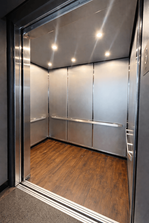 Danville apartment for rent - A stainless steel elevator with a glass door and wood flooring inside.