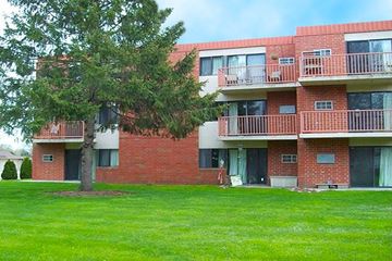 Coralville apartment for rent - A red brick apartment building with a green lawn in front.