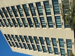 Oak Park apartment for rent - A tall building with many windows and a tree on the right side.