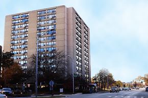 Oak Park apartment for rent - A tall building with many windows is in the background of a street scene.