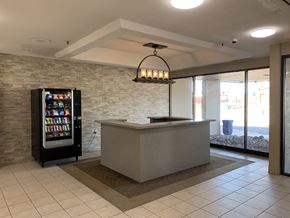Springfield apartment for rent - a lobby with a reception desk and a vending machine