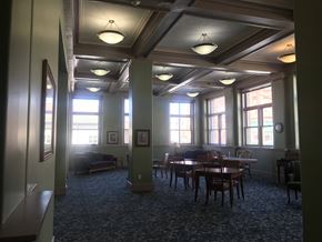 Fort Dodge apartment for rent - a large room with a row of windows and tables and chairs