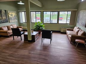 Wahoo apartment for rent - A living room with brown floors and furniture.