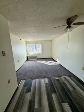 Omaha apartment for rent - A room with a ceiling fan and a window.